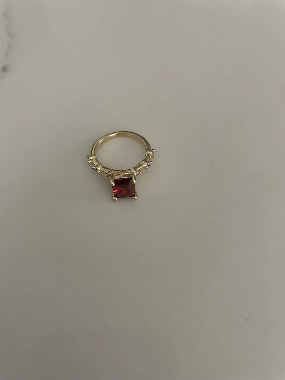 Gold tone Ring with Square red / orange colored center and Accent Stones